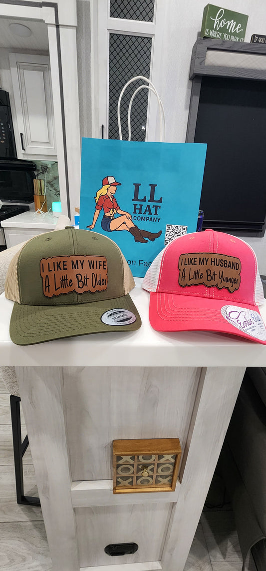 Couple hats " I like my husband   a little bit younger " &  " I like my wife a little bit older "